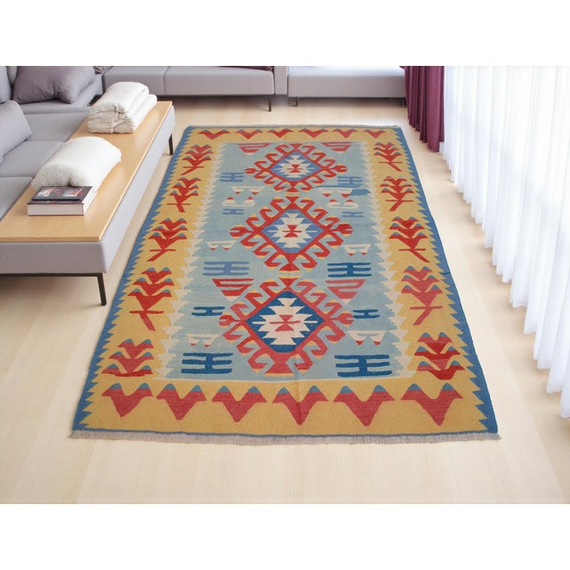 Handwoven in Turkey during the 1980s, this authentic Anatolian kilim embodies centuries of weaving tradition and artisanal...