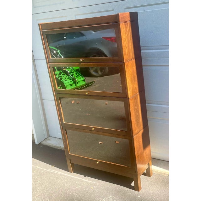 Offered is a four stack bookcase in mission oak. It was manufactured by the C. J. Lundstrom Manufacturing Company. The...