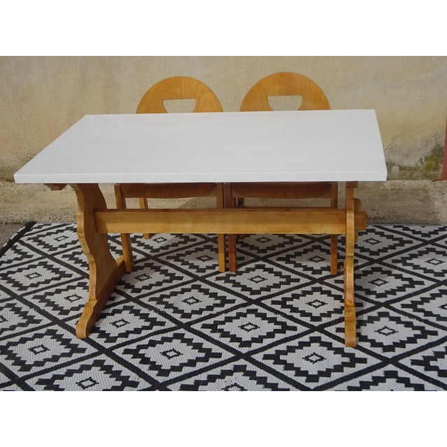 Pine dining table with monastery-style legs. The tabletop is painted white and protected with a colorless, water-...