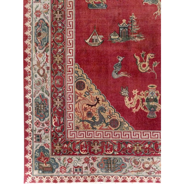 This Mid-20th century Chinese Inspired Turkish room-size carpet presents an elaborate pictorial composition across a rich...