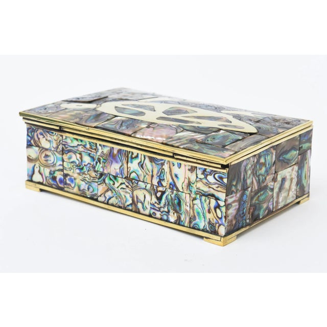 This vintage mid century modern abalone, brass and rosewood hinged box has a wonderful brass turtle on the top floating on...
