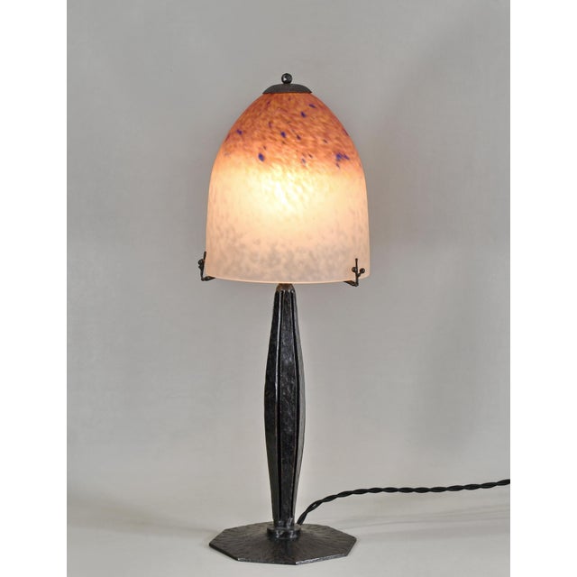Schneider A French art deco lamp in wrought iron made around 1925-1930. It holds a beautiful colored dome in mottled...
