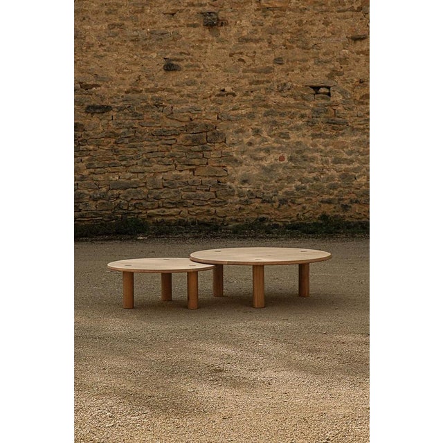 Set of 2 nahele varnished oak nesting tables by la lune dimensions: ø 105 x h 34 cm. Small: ø 80 x h 30 cm. Materials:...