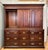 Antique storage cabinet made of dark stained quarter sawn oak with recessed brass hardware. It features nine dovetail...