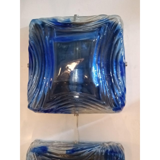 A splendid and unique pair of light blue Murano glass wall lamps by Mazzega Murano. These lamps were designed and...