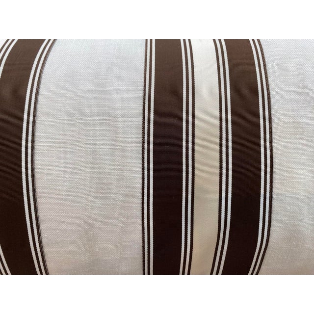This bolster pillow features a classic striped pattern in brown and cream, creating a timeless, versatile look. The...