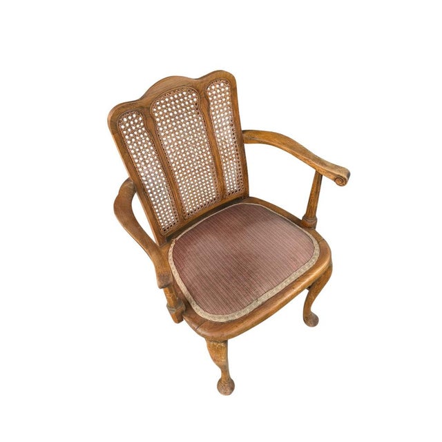 Features a high, triple-section cane backrest with openwork woven patterns, set inside a curved wooden fram. Curved wooden...