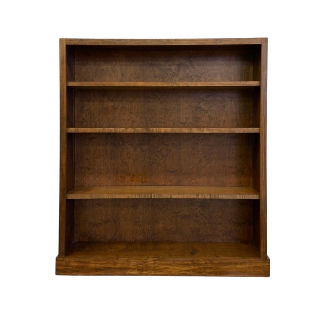 This mid-century modern bookcase features a rich, warm wood finish highlighting subtle burl-like grain variation...