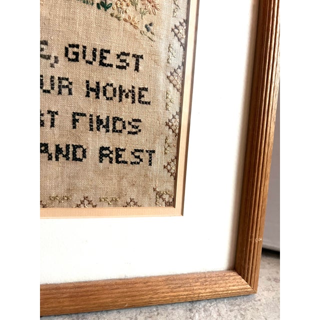 This is a Vintage Cross Stitch Needlepoint Art Framed . This has a cottage design and the welcoming phrase "Welcome, guest...