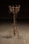 Hand-forged wrought iron jardinière stand featuring a basket-form top constructed from riveted strapwork, encircled by...
