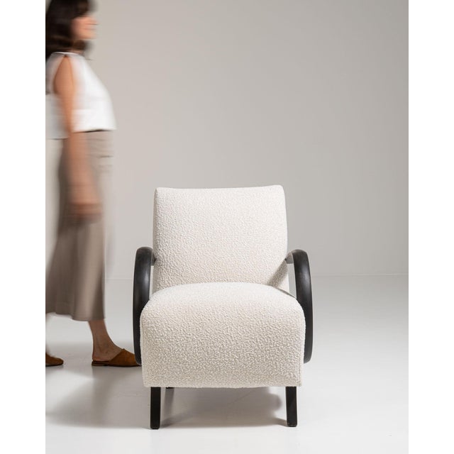 Bentwood-arm lounge chair in Warm Ivory Boucle. Its warm ivory boucle finish sets off curved black wood open arms, ivory...