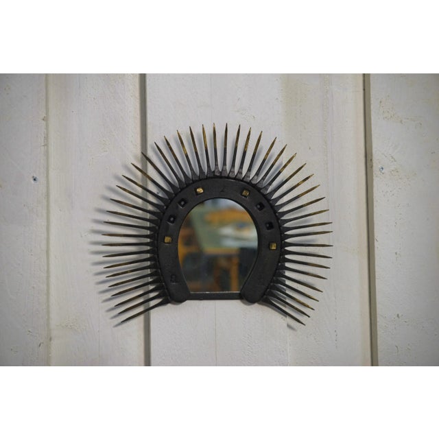 This mirror perfectly evokes the artisanal Brutalist aesthetic of the 1950s and 1970s: a circular format mounted on a raw...