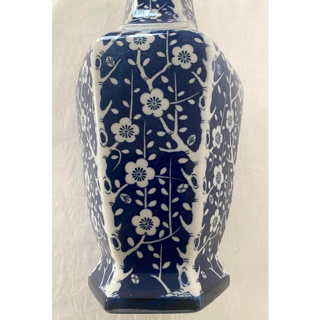 Vintage Blue and White Unique Vase. Measures 16 1/8 inches in width in height, 7 inches in width, 7 inches in depth...