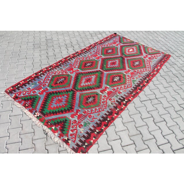 This beautiful, vintage, handwoven kilim is approximately 60 years old. It is handmade, of very fine quality hand spun...