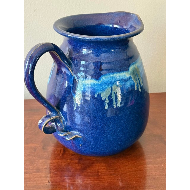 Exquisite vibrant blue studio pottery pitcher with double looped handle, made and signed by an accomplished potter....