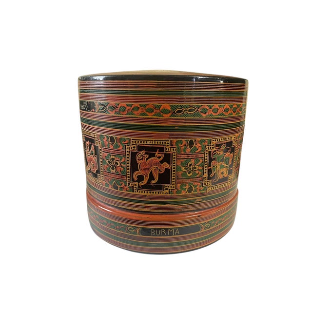 This Vintage Burmese Lacquer wood hand-painted betel box dates back to the 1982 Originating from Burma, depicting the...