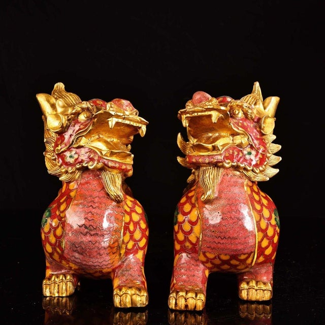 This striking pair of gilt cloisonne enamel Qilin figures brings a bold, majestic presence to any interior. Qilin are...