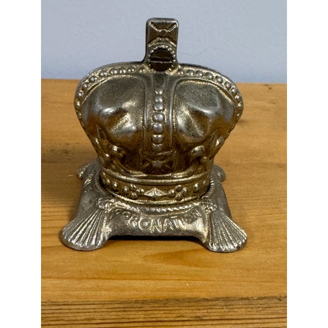A rare and delightful brass commemorative coin bank from the coronation of Elizabeth II. Beautifully detailed. Hand...
