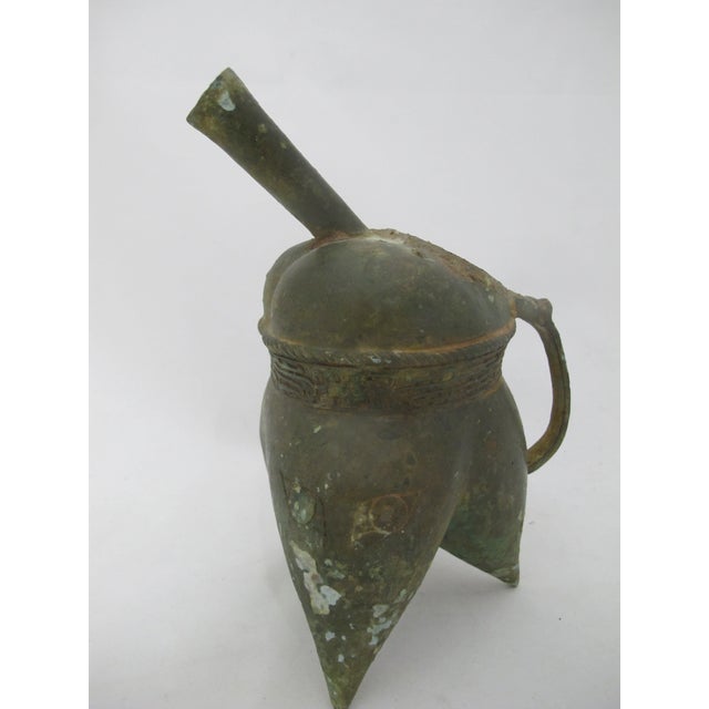 Chinese antique vessel, a replica of an ancient Chinese ritual wine vessel, deeply oxidized bronze with an incised...