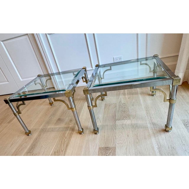 Beautiful pair of vintage 1970s side tables in the manner of Maison Jansen and Mastercraft, featuring polished chrome...