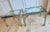Beautiful pair of vintage 1970s side tables in the manner of Maison Jansen and Mastercraft, featuring polished chrome...