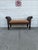 We have an absolutely stunning vintage boho rattan bench for sale. It features woven wicker construction, dramatic scroll...