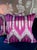 Pink and purple ikat stripes feather into a bold arched motif across these custom throw pillows in Schumacher Bukhara...