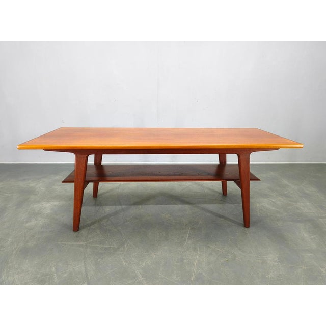Refined Danish mid century coffee table from the 1960s, executed in solid teak with a teak veneered top. The sculptural...