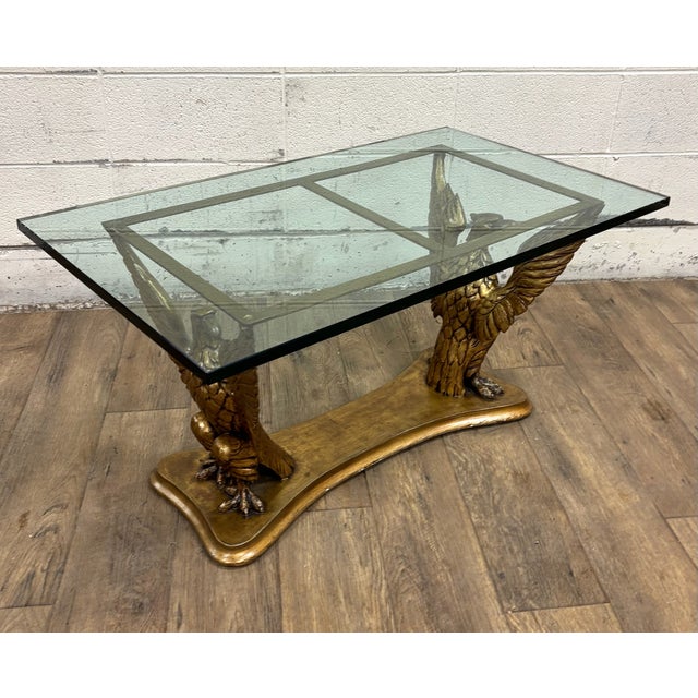 This is a gorgeous vintage late 20th century Regency Neoclassical style wooden eagle base glass top coffee table or...