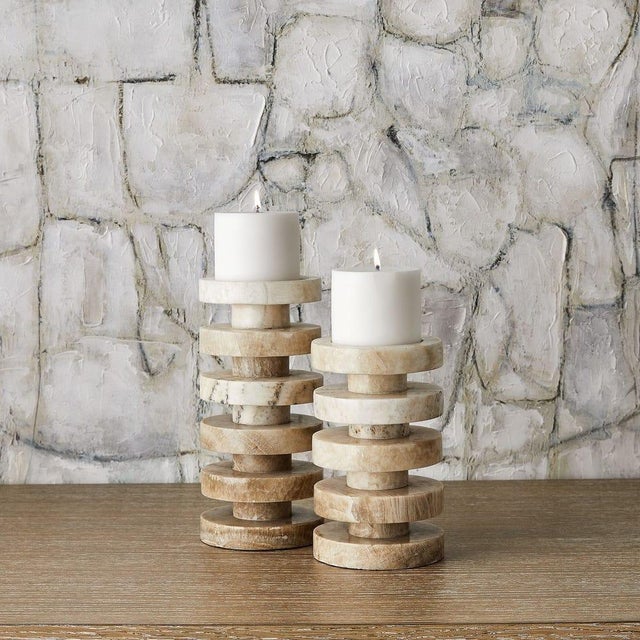 Bring sculptural warmth and natural elegance to any setting with this set of two onyx pillar candleholders, each crafted...