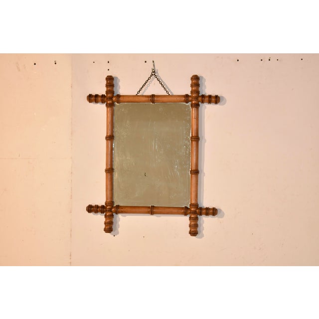 Lovely French wall mirror made from cherry, circa 1900. The frame has been hand turned from cherry and is in the style of...