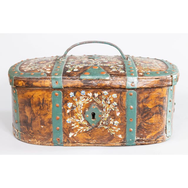 An incredible Swedish hand-painted chest or trunk, having hand-forged iron straps and fittings. Original key included.