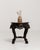 A decorative pedestal table featuring intricate carved detailing and a marble top. The craftsmanship reflects traditional...