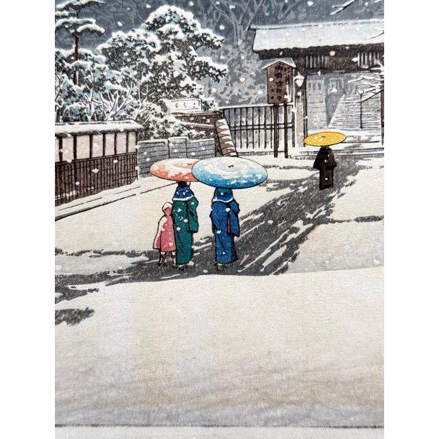 A pre-war fine print by Kawase Hasui (1883–1957) depicts the approach to the famous temple in Tokyo Ikegami Honmon-ji on a...