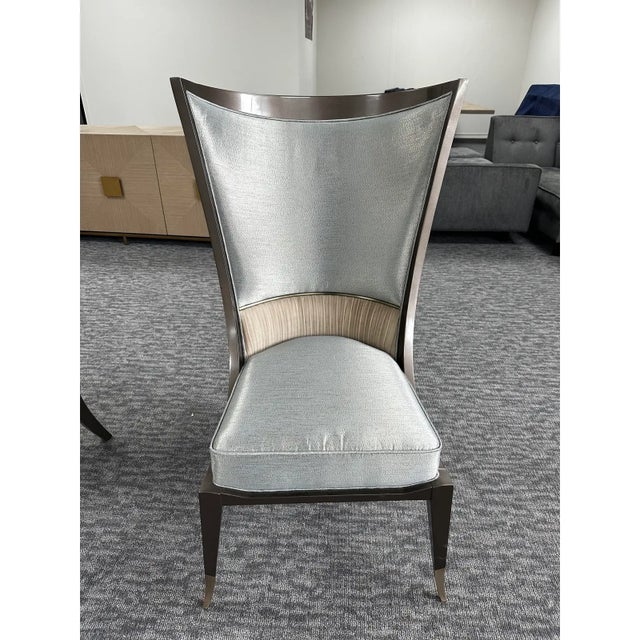 Elevate your space with this striking pair of Caracole "Collar Up" chairs, designed to make a bold statement. With their...