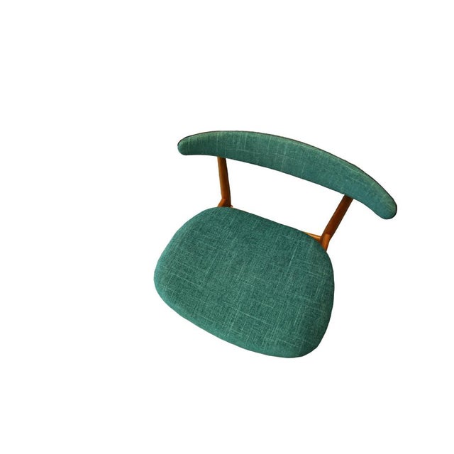 A set of four stylish teak chairs designed by Knud Faerch in Denmark. The chair has round tapered legs that are connected...