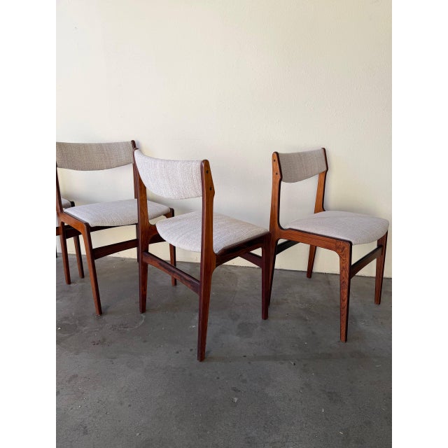 Set of four authentic Danish Mid Century Modern dining chairs in style of Erik Buch. These elegant chairs feature...