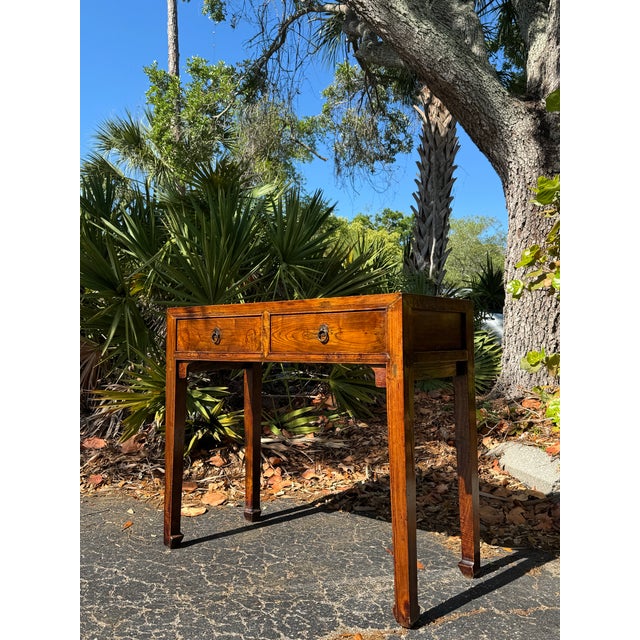 A beautiful antique Chinese Ming-style console table or writing desk featuring clean architectural lines and a richly...