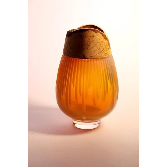 Iris Amber Frida with cuts stacking vessel, Pia Wüstenberg Dimensions: D 13 x H 20 Materials: cut glass, wood with its...