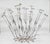 This mid-century kinetic sculpture depicts a cluster of flowering stems with a single bee resting on one of the blossoms....
