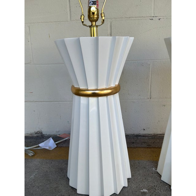 Stylish Currey & Co Cinched White Lacquer Lamps - Pair. Bulky hourglass shaped cinched body, gold band in the middle....