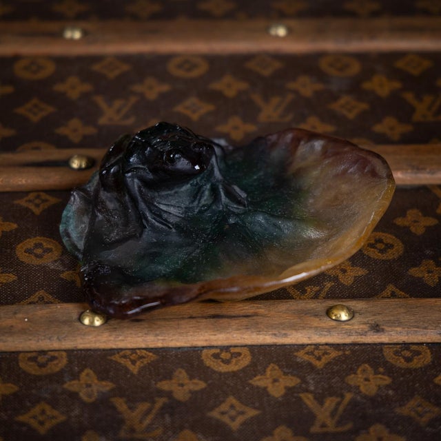 A 20th century pâte de verre frog on a lily pad by the french maker daum. Created using a blend of glass powders and...