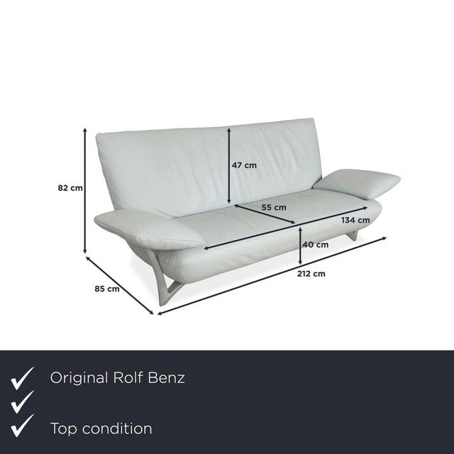 The 1900 three-seater by Rolf Benz is upholstered in light blue genuine leather. The curved metal frame of the armrests is...