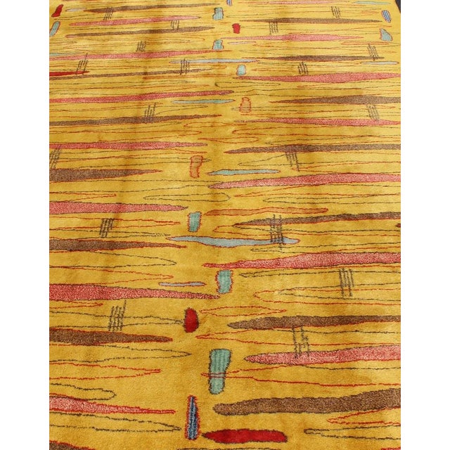 Mid-century modern rug with yellow background and multicolored etched pattern. Keivan Woven Arts / rug TU-MTU-04, country...