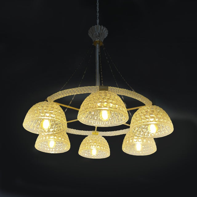 Italian Art Deco glass and brass chandelier, 1930s Chandelier featuring a circular burnished brass frame with a radial...