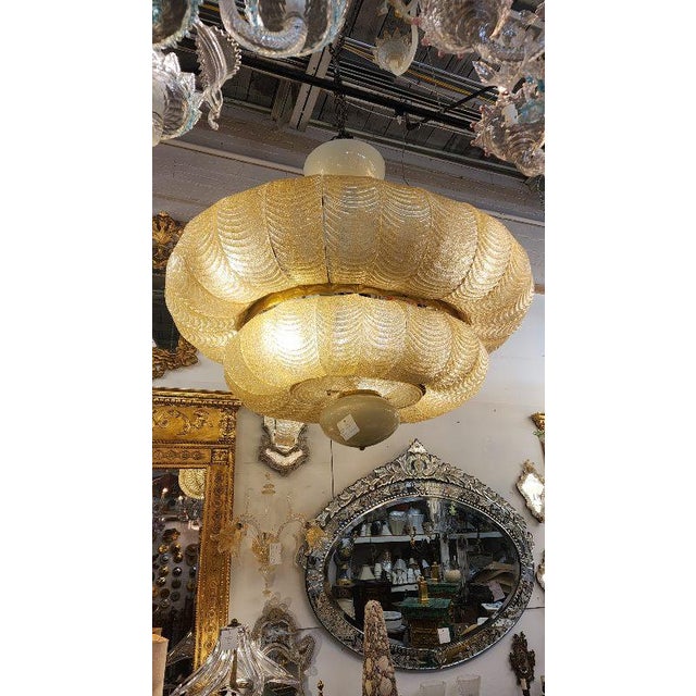 This listing features a beautiful large Murano Glass Chandelier, with cascading feather-like yellow tinted glass...