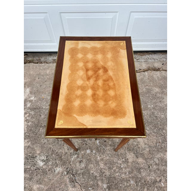 An elegant 19th-century Louis XVI side table, finely crafted in mahogany with a beautiful parquetry top and a single...