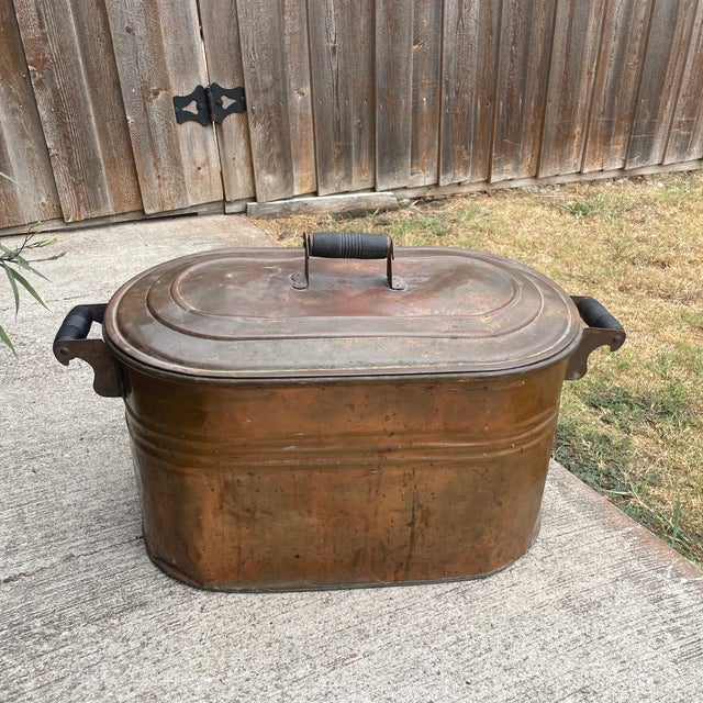 late 19th-century Early American primitive copper boiler wash tub with its original dark-patinated matching lid. It...