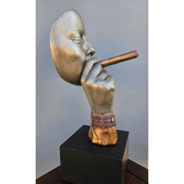 This 1997 John Cutrone "Panama" sculpture by Austin Productions features a man smoking a cigar and is approximately 16...
