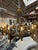 An impressive Italian twelve-light chandelier executed in a sculptural Brutalist style, featuring a richly patinated...